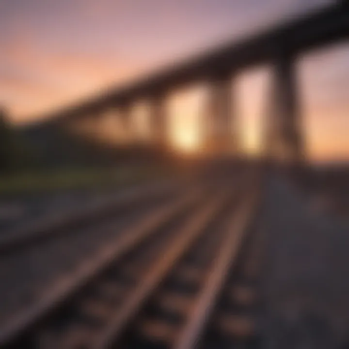 A picturesque sunset illuminating a bridge with a train passing